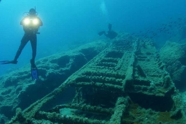 a scuba diver explores queen olga remnants in Leros deep waters.